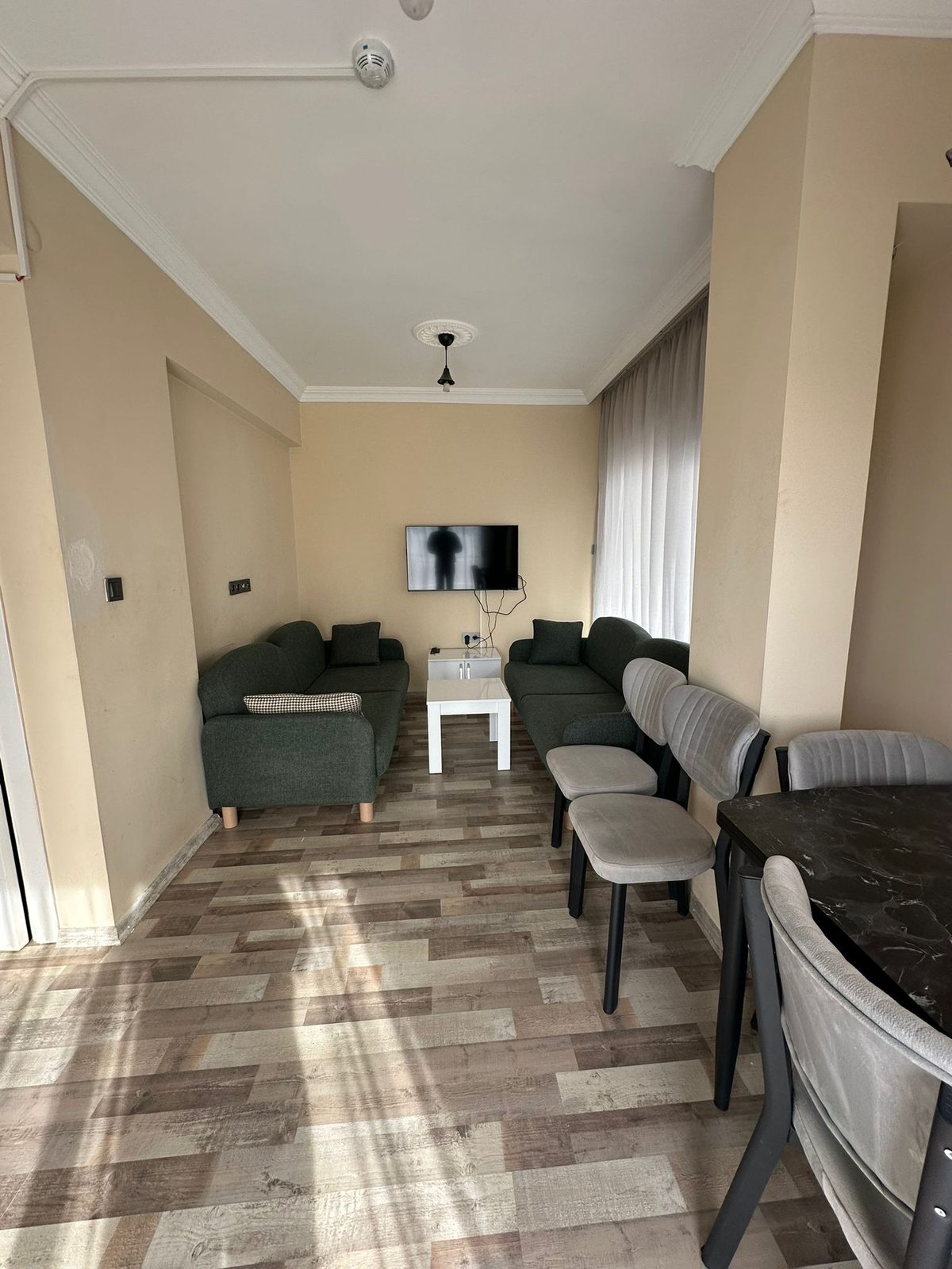 Living room of the Lara Duplex apartment with seating for six and a mounted television