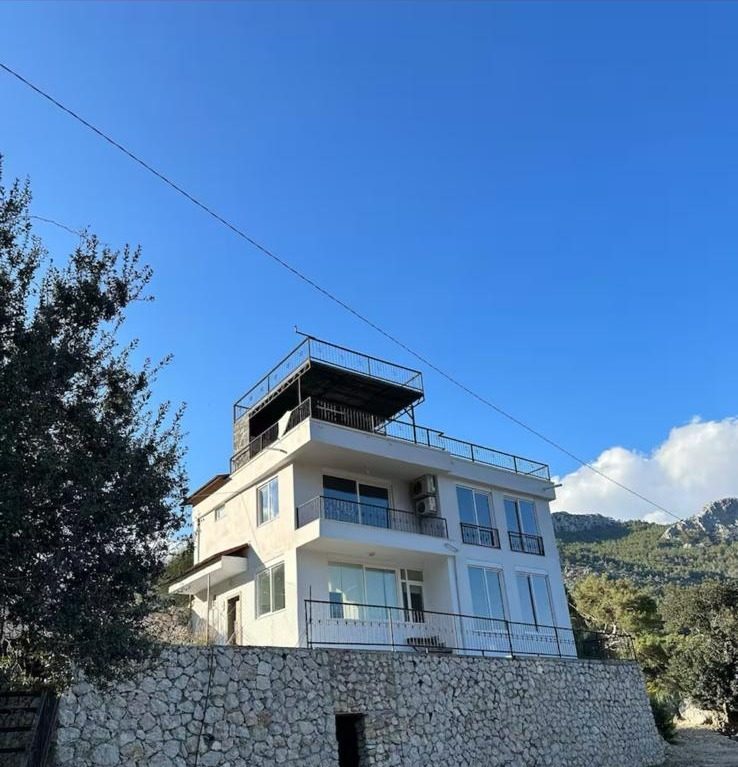 Gedeller Villa, a white three-storey villa on a hillside in the pine forests above Antalya